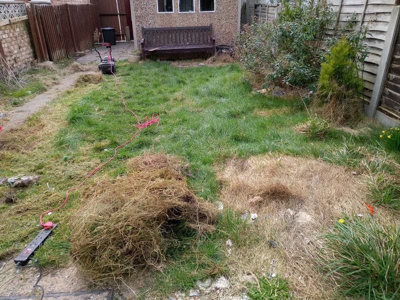 Untidy,Back,Garden,With,Rubbish,And,Lumpy,Green,Grass